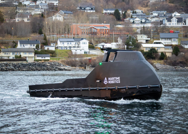 The black-colored Mariner X USV patrolling near the coast.