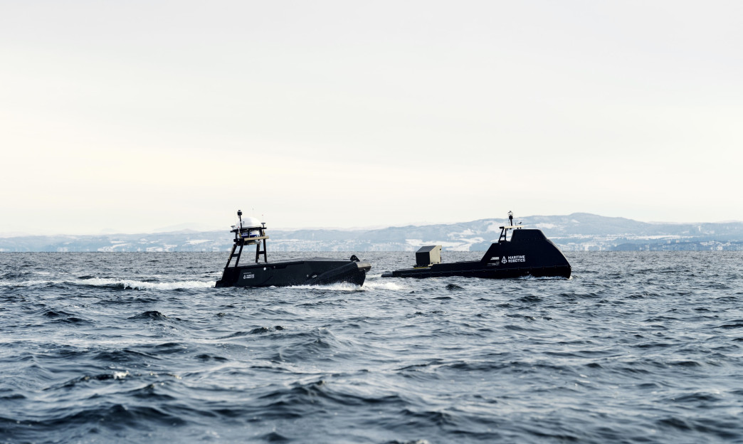 Two uncrewed surface vessels (Mariner and Mariner X) by Maritime Robotics operating together in open sea.