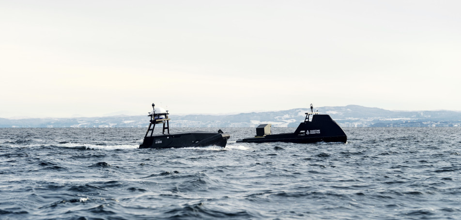 Two uncrewed surface vessels (Mariner and Mariner X) by Maritime Robotics operating together in open sea.