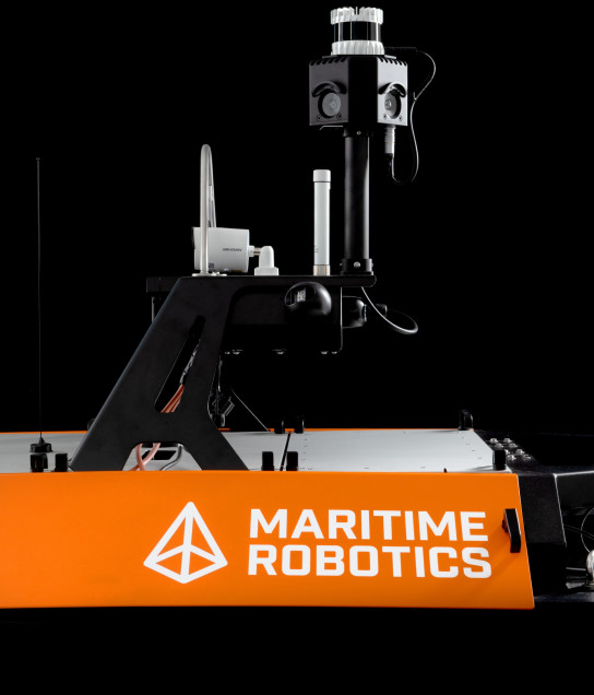 Close-up of Otter USV with SeaSight mounted, showing cameras and instrumentation on black background.