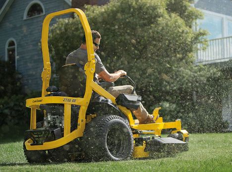 man on zero turn mower rear view